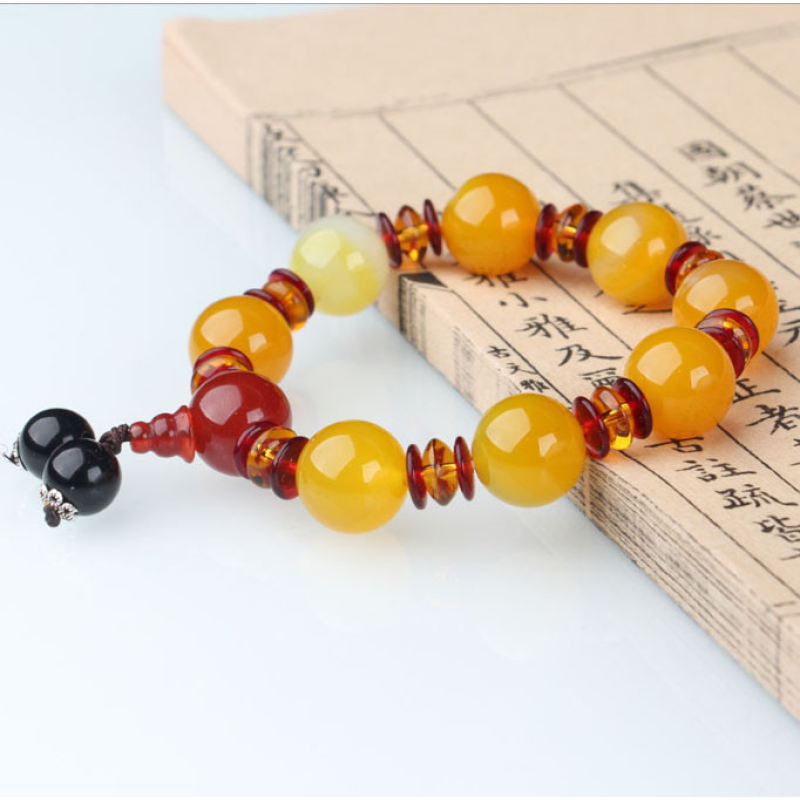 Браслет імітація бурштину з пензликом